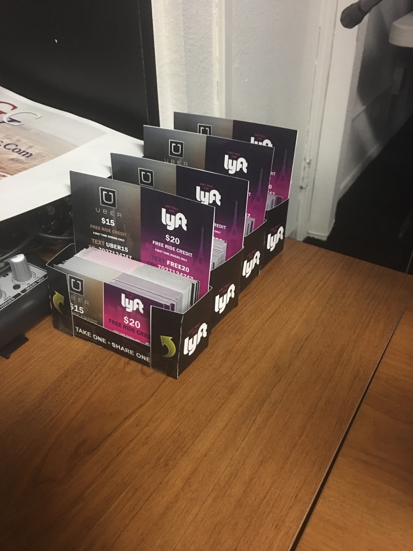 Uber and Lyft counter display boxes lined up for dual-brand distribution