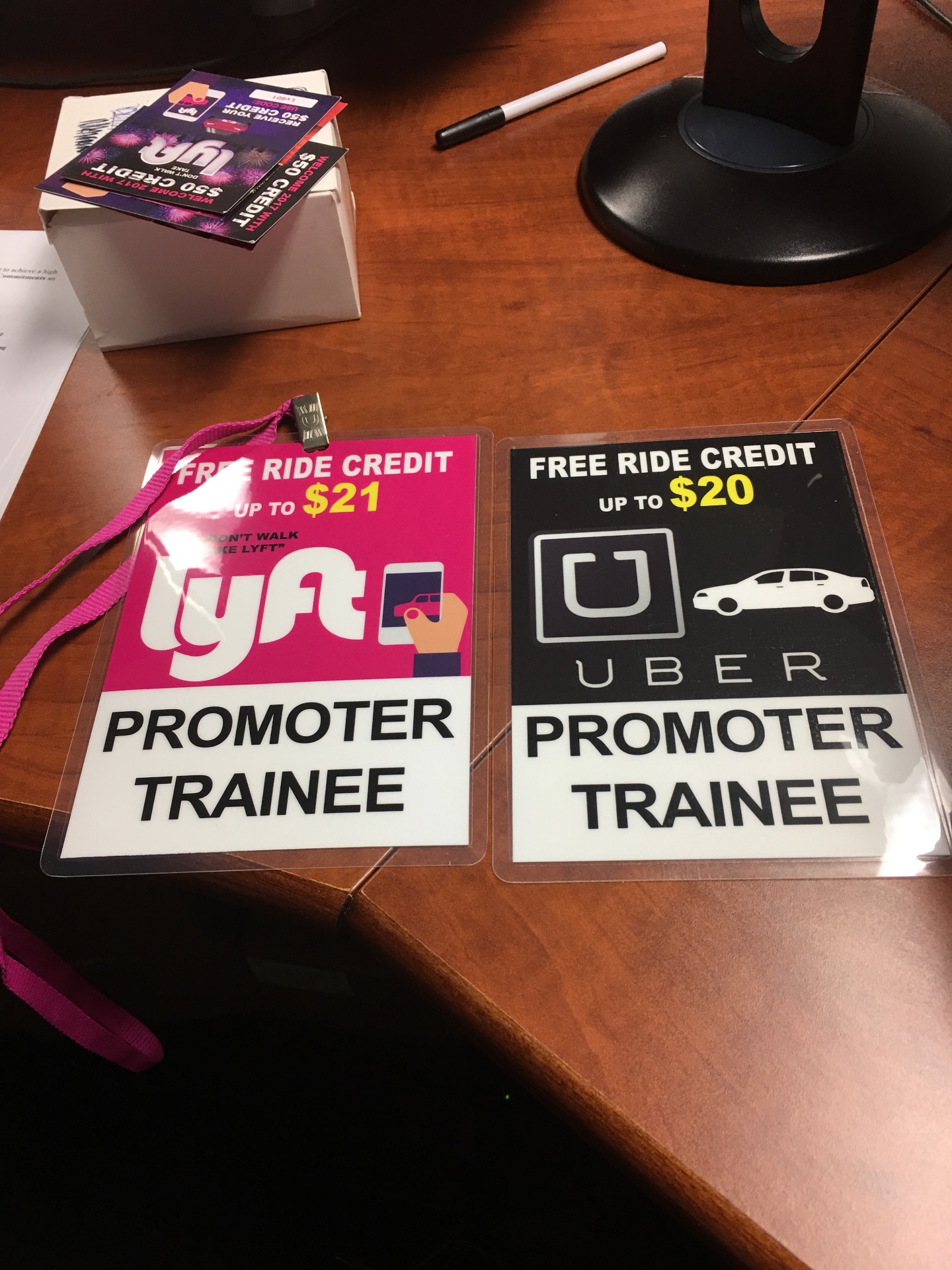 Laminated Uber and Lyft promoter trainee badges with free ride credit offers