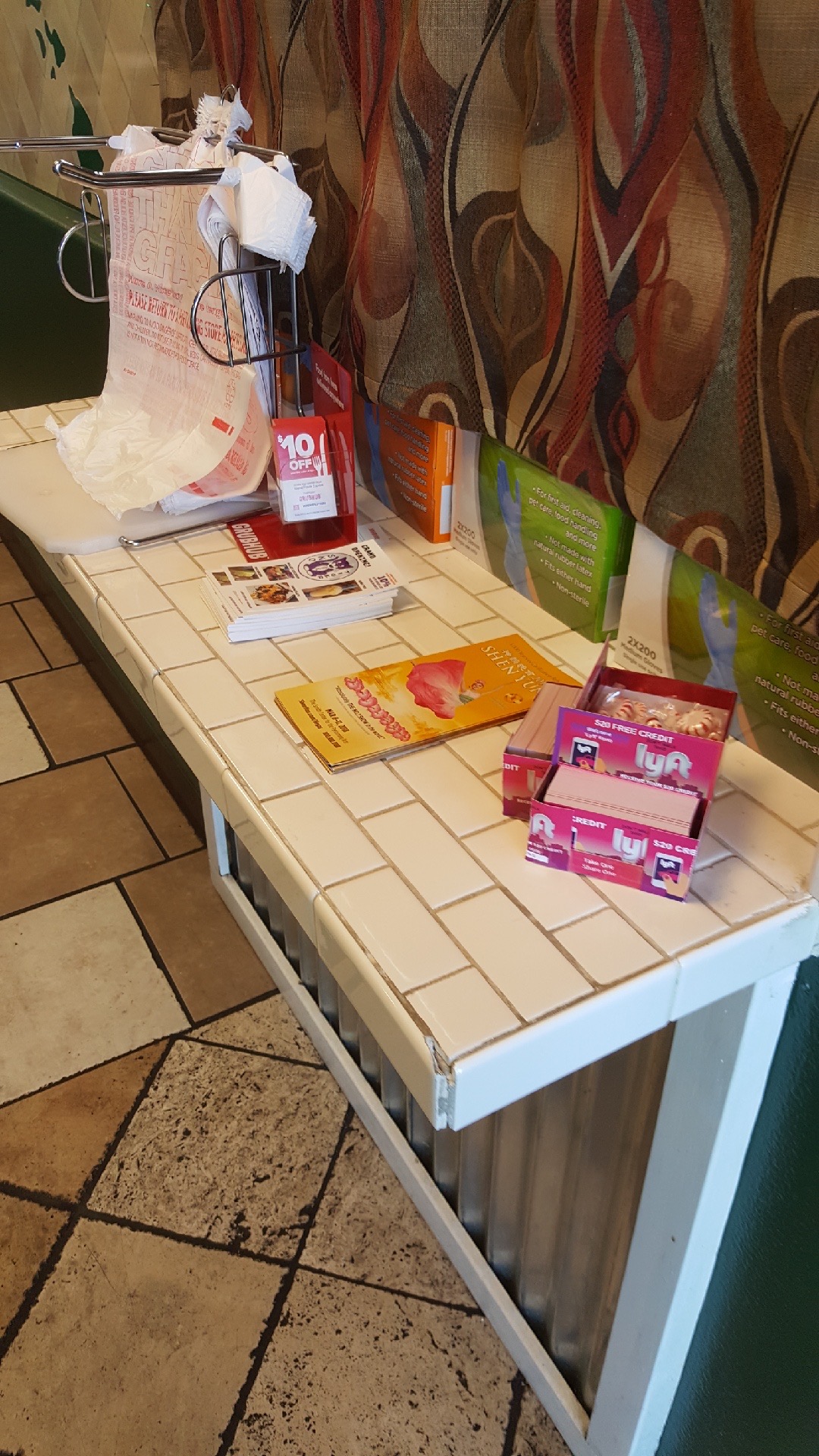 Lyft referral box placed on a local business counter next to the register